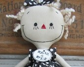 handmade cloth doll in a Black and White Polka Dot Dress with Aqua striped tights and shoes