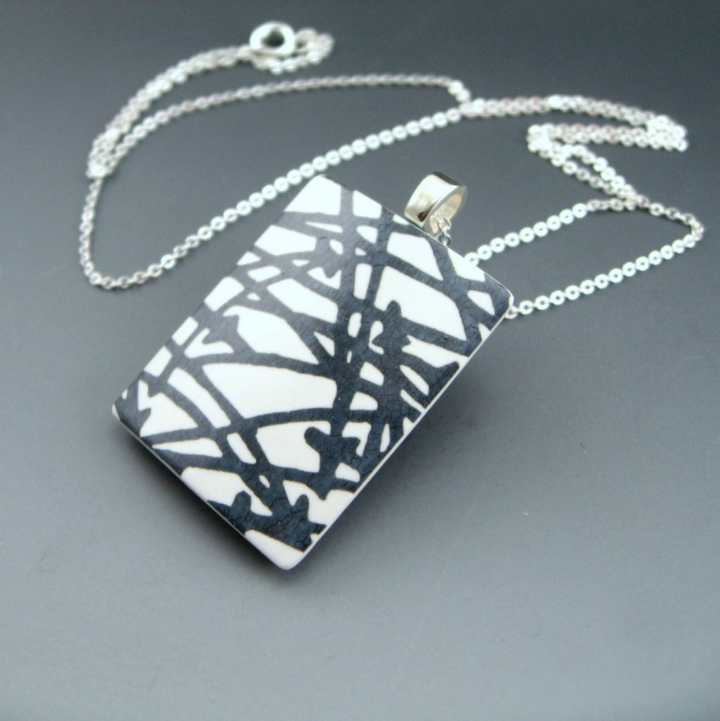 Modern and simple black and white pendant necklace with a pop of color
