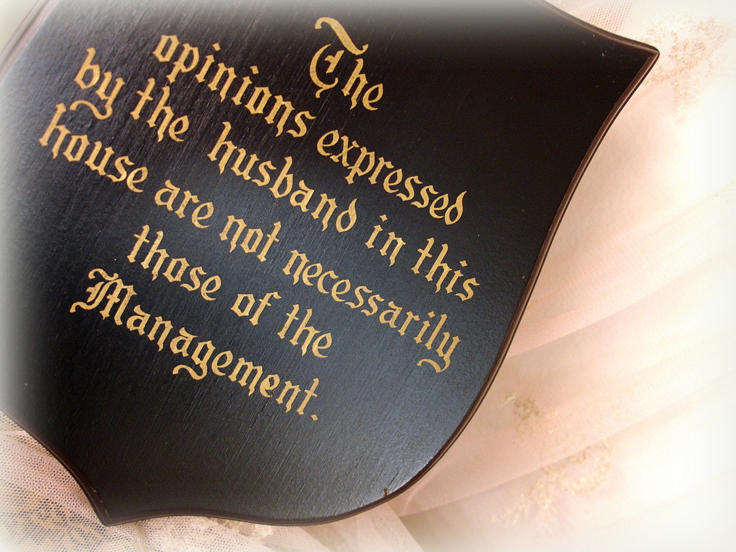 kitschy vintage wall plaque gag gift . shield shaped wood painted black with gold lettering . husband of the house