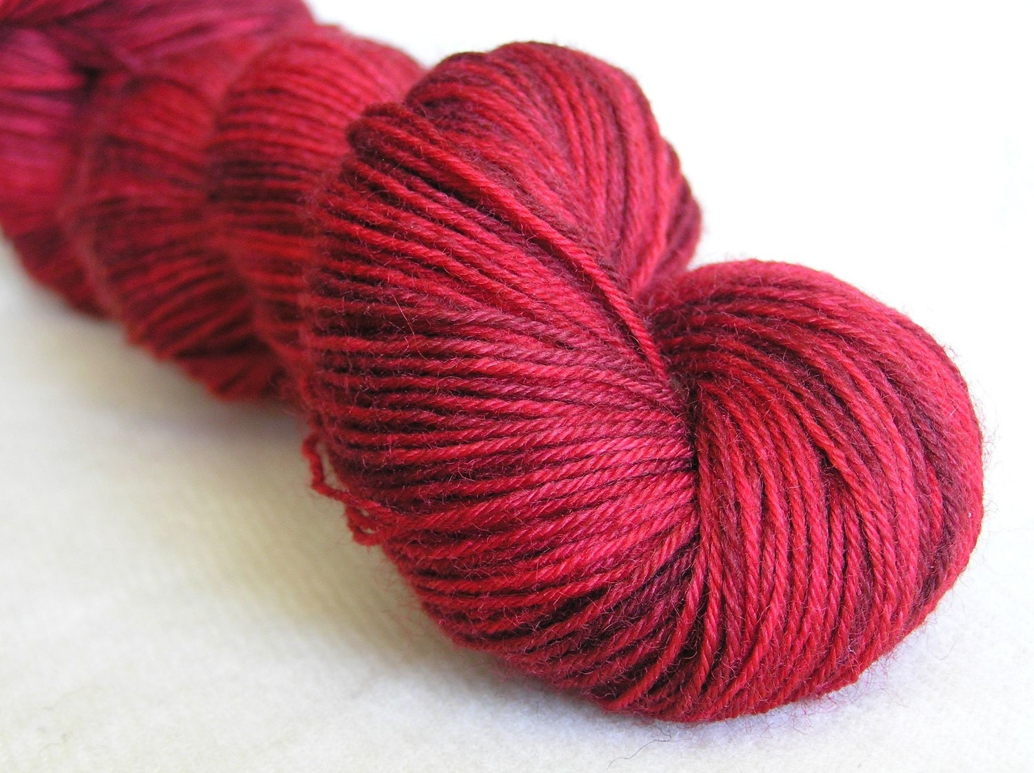 100g superwash sock yarn with nylon, reds