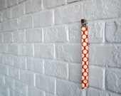 pacifier clip, in red polkadot.