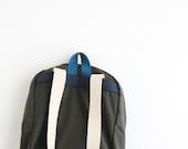 military green backpack with denim pouch.