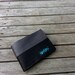 Seat belt wallet made from reclaimed seat belt straps and used bike inner tube