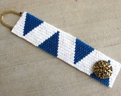 Nautical Pennants cuff,  Cadet blue and iridescent white with oversize baroque golden button. 7 inch long