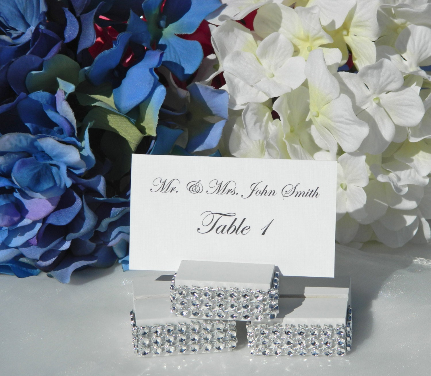 White wood place card holders trimmed with a rhinestone wrap -Set of 100