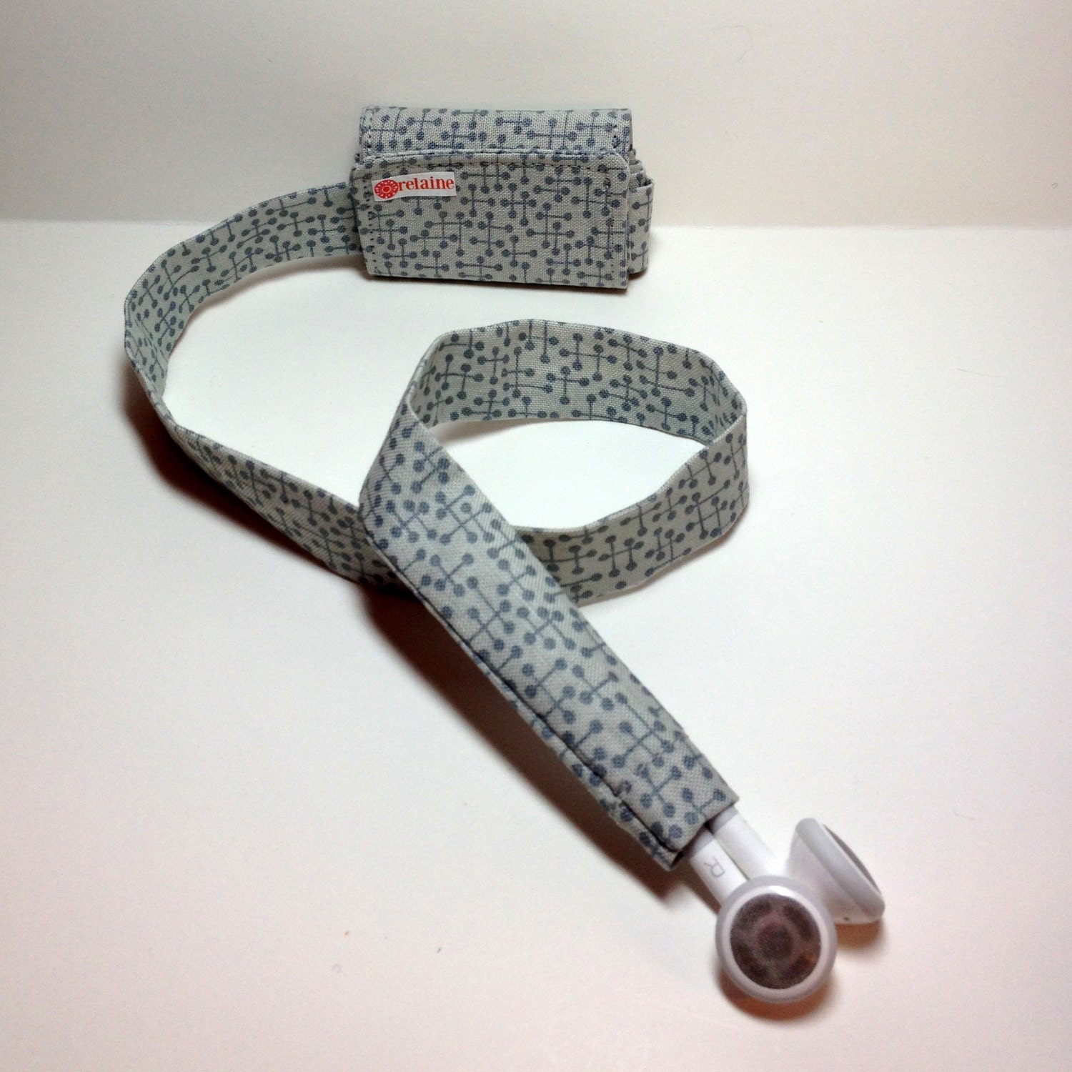 Gray TuneTube.  Earbud cord organizer for iPhone or iPod.  Cord keeper.  Earbud holder.  Earbud case.