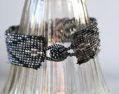 vintage beaded bracelet. Black, gunmetal, silver, pink irridescent bead toggle bracelet. Graphic geometric tribal.
