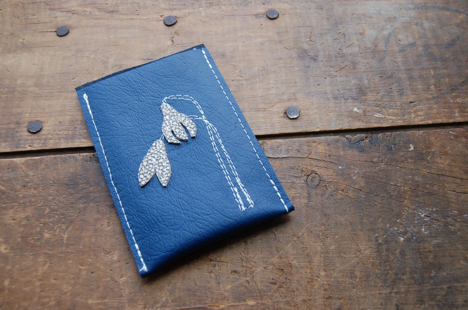 snowdrops on blue repurposed leather phone sleeve