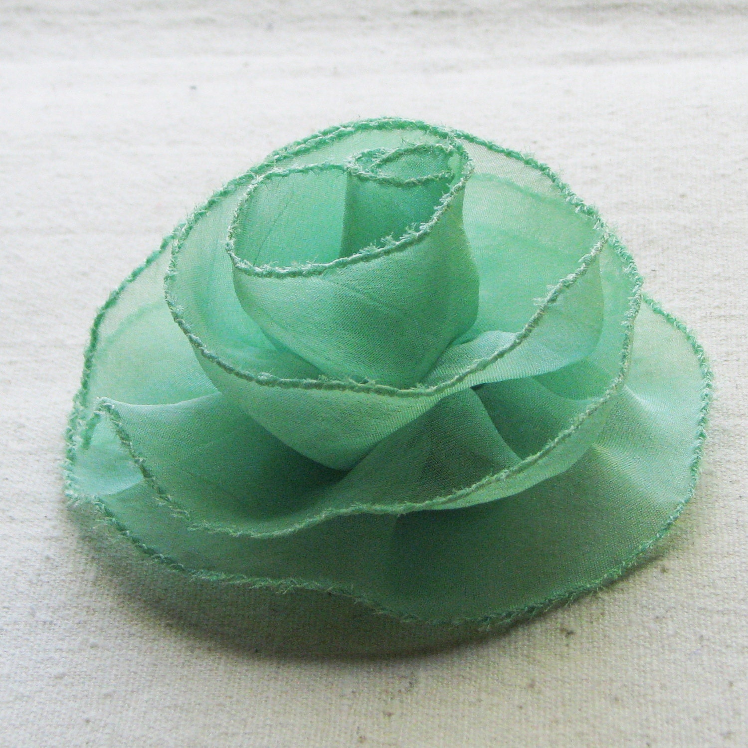 Rose hair clip in airy mint green chiffon, medium-large fabric flower with stitched edge