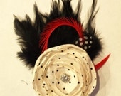 Cream and Black Polka Dot flower accented with black and Red Feathers.