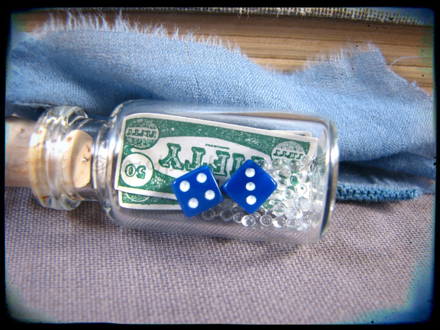 The gambler's bottle charm. Miniature dice, money, blue silk. Glass bottle necklace.