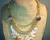 Orange floral brooch and chain recycled leather necklace