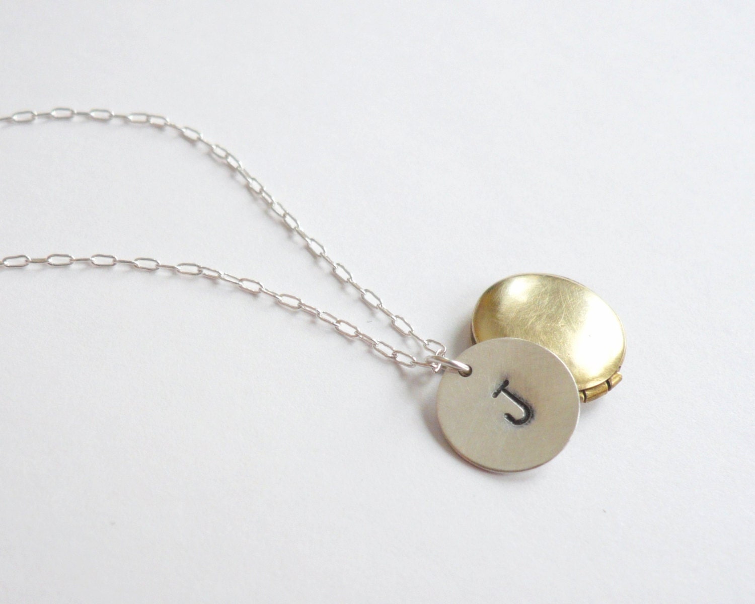 Personalized bridesmaid locket necklace. Mixed metal monogrammed necklace in sterling silver and brass gold.