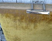 A velvet photo album, victorian era with no photos, gold color with clasp