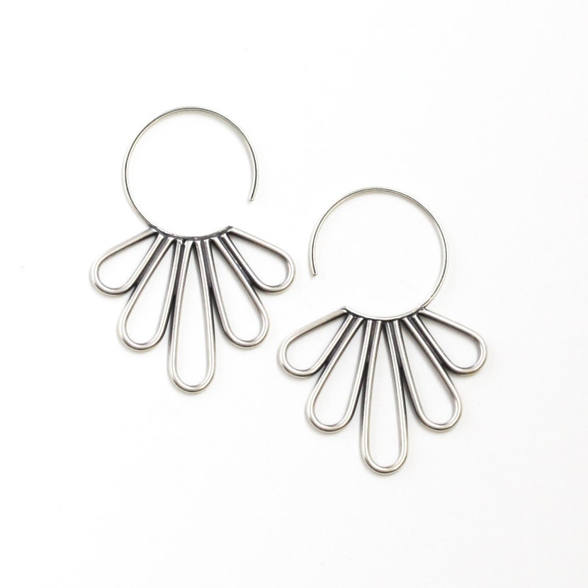 Elegant silver earrings with feather shapes soldered together to a hoop to make a modern piece of jewelry - "Peacock Hoop Earrings"