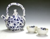 Porcelain and ceramic pottery tea set with two matching tea bowls.