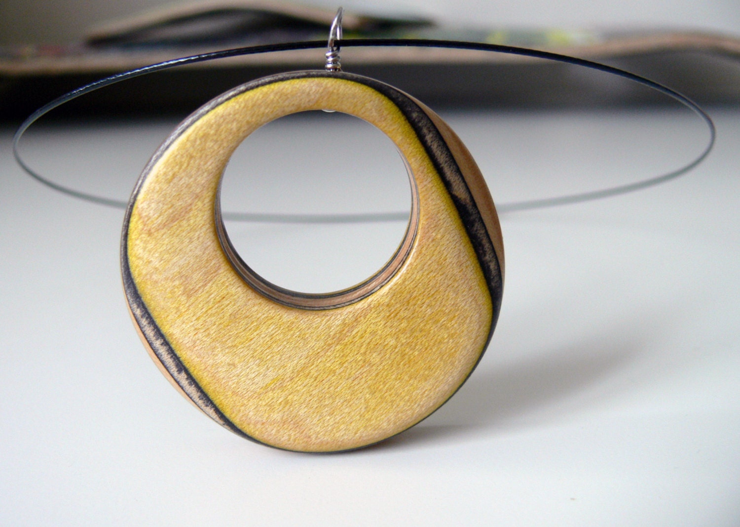 Yellow, Black and Natural Recycled Skateboard Reversible Wood Pendant on a Black Wire Necklace with Yellow, Black and Glitter Graphic