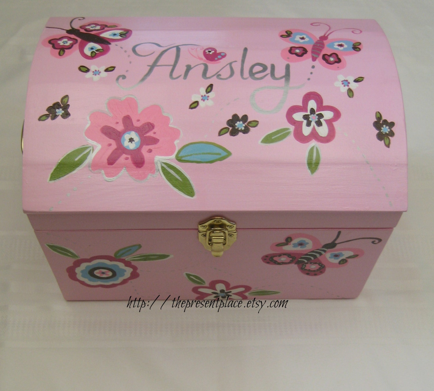 An extra large keepsake box painted to match sumersault bedding with butterflies and flowers