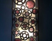 Recycled bicycle cog wall sconce with colored stained glass
