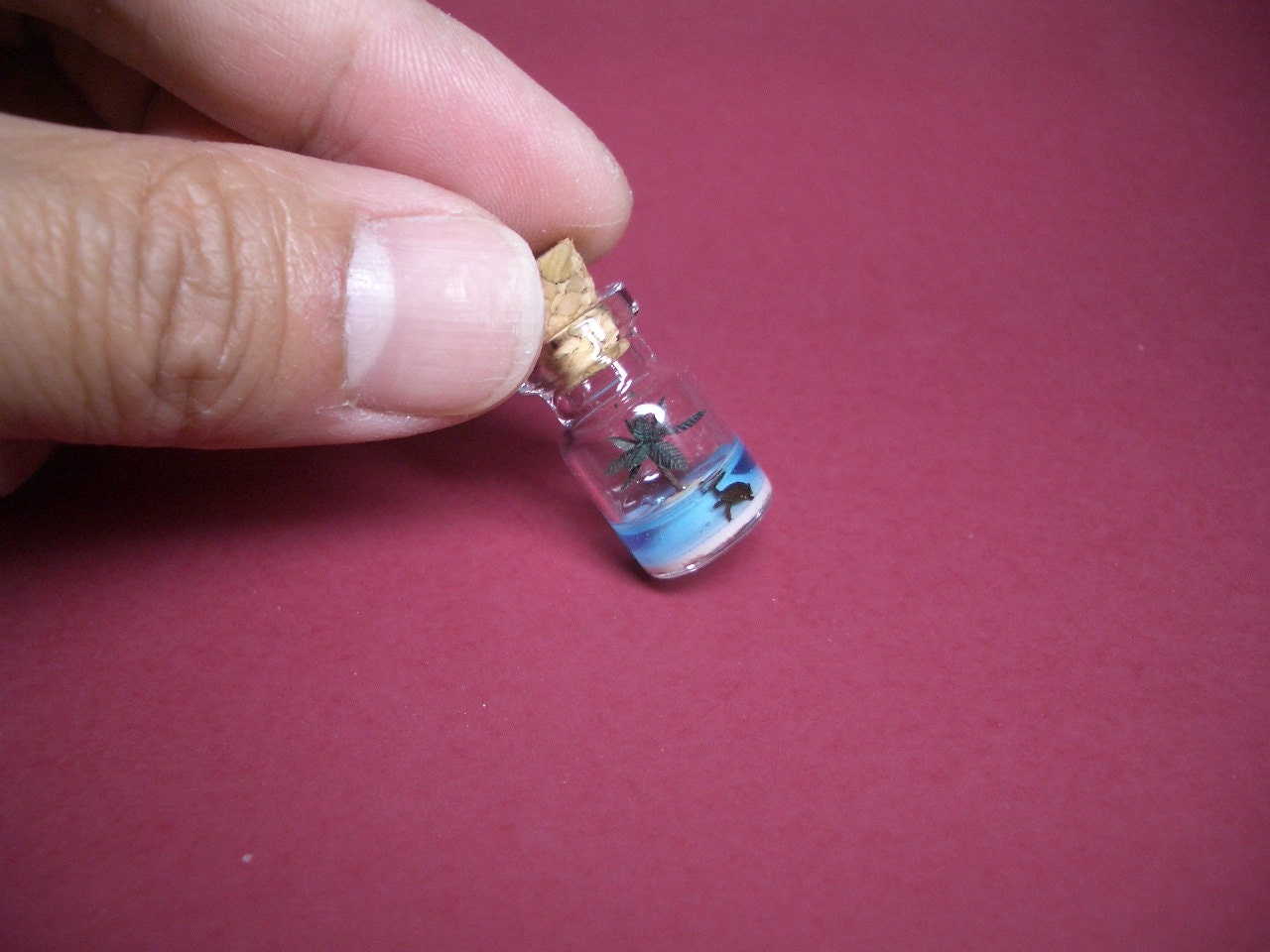 A turtle in an uninhabited island with a palm tree in a tiny bottle blue ver.3