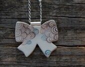 Ceramic bow pendant on sterling silver chain and bail