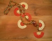 crochet necklace, orange, cream, green