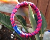 Pink and blue fiber bracelet with silver charm