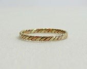 Elegant Gold Twist Wedding Band in Rose, White, and Yellow Gold.