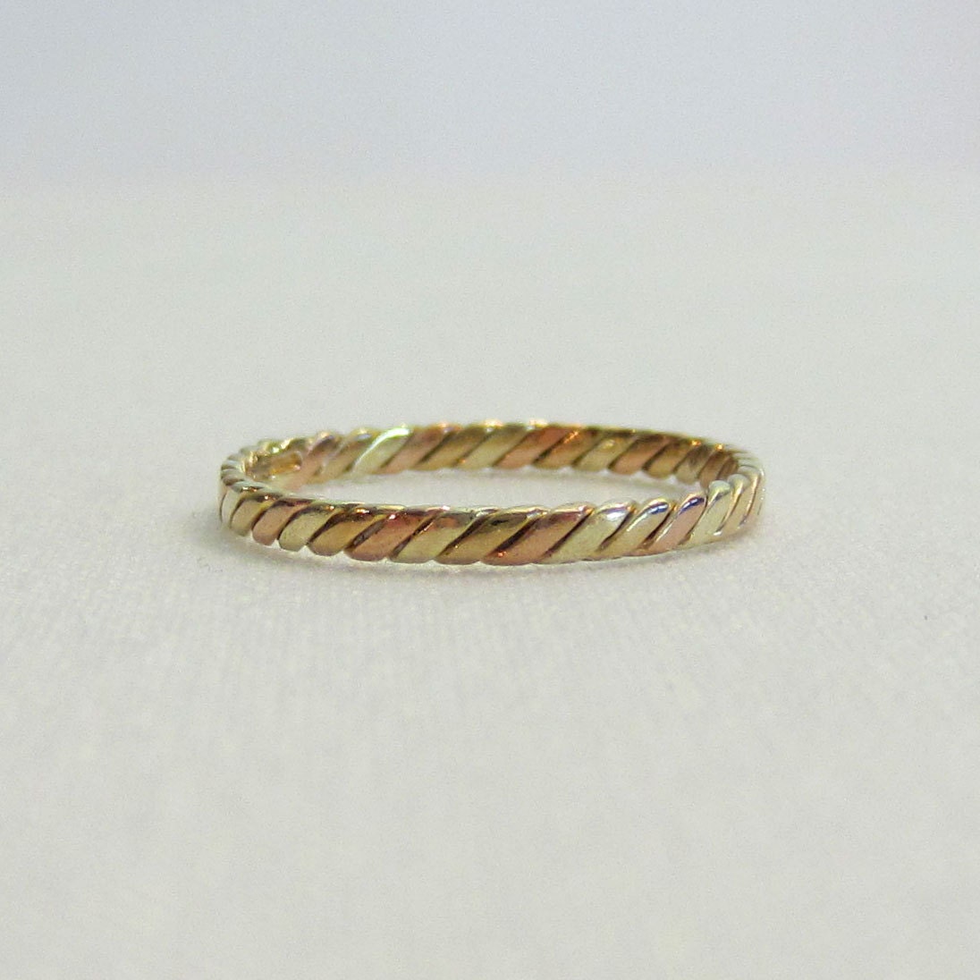 Elegant Gold Twist Wedding Band in Rose, White, and Yellow Gold.