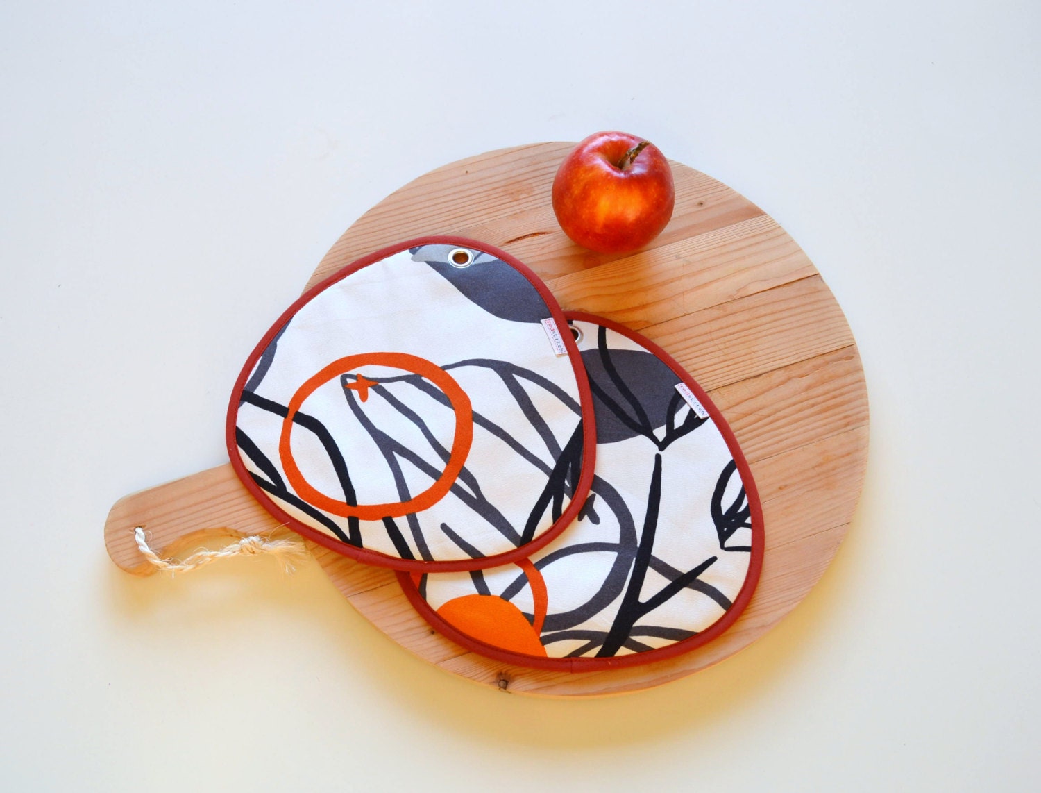 neutral potholders with print in grey and rust orange - modern kitchen potholders - fruit