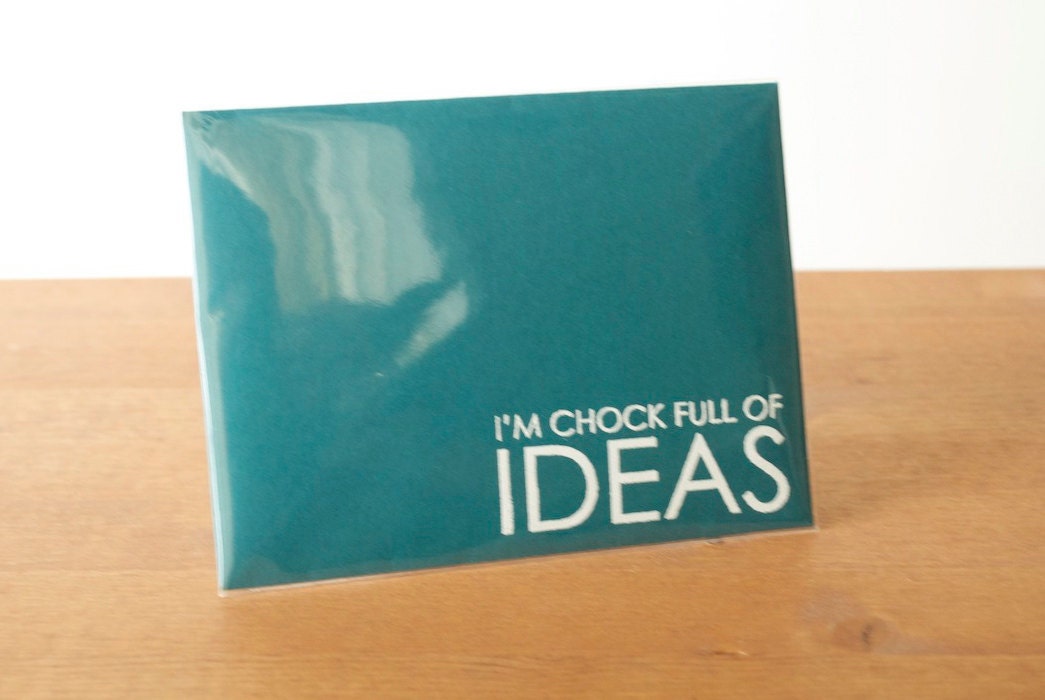 dark teal envelope single: chock full of IDEAS