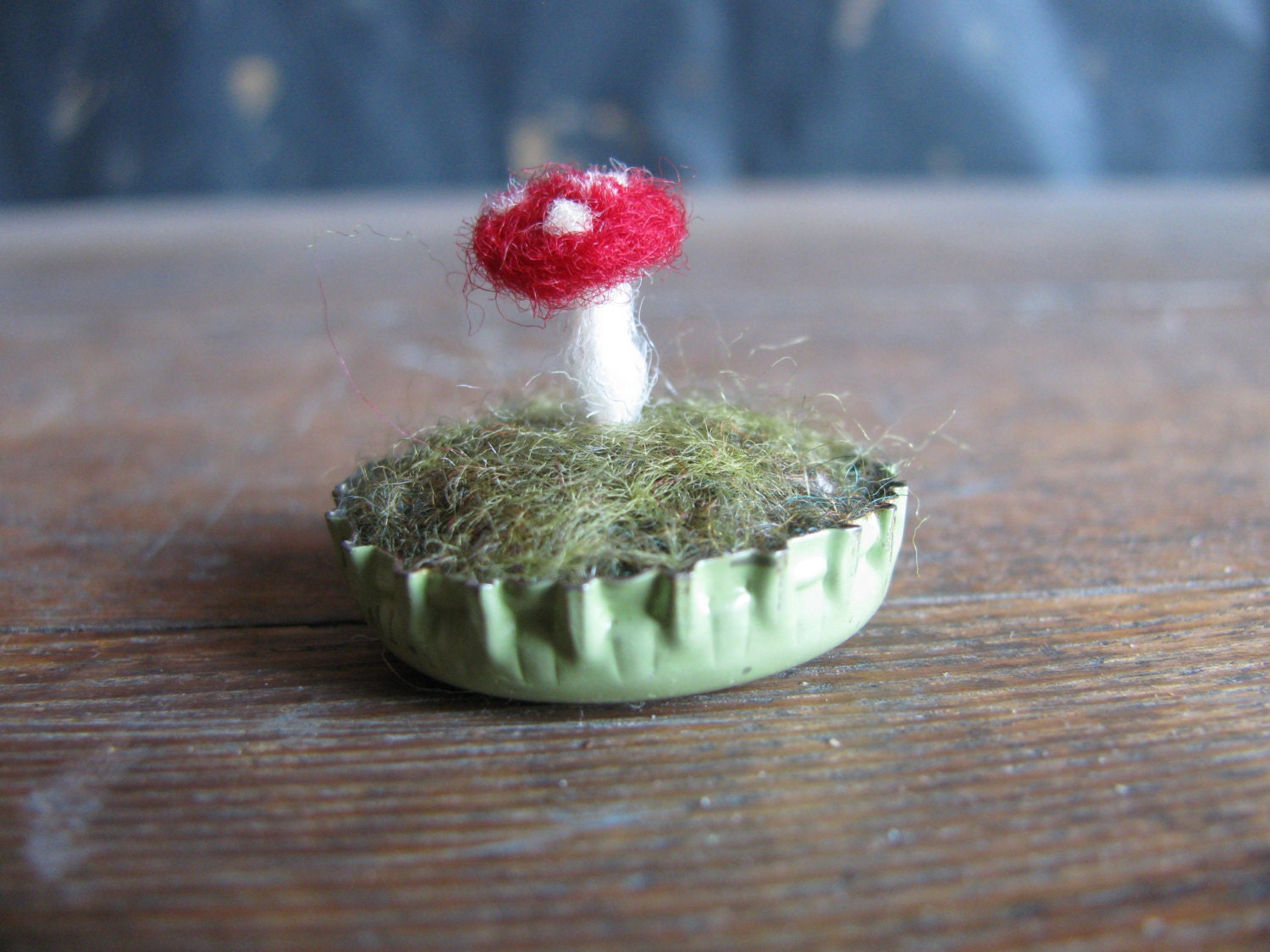 Felted amanita mushroom in a pastel green bottlecap