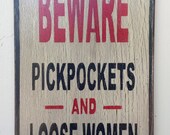 Beware pickpockets and loose women sign made from reclaimed plywood