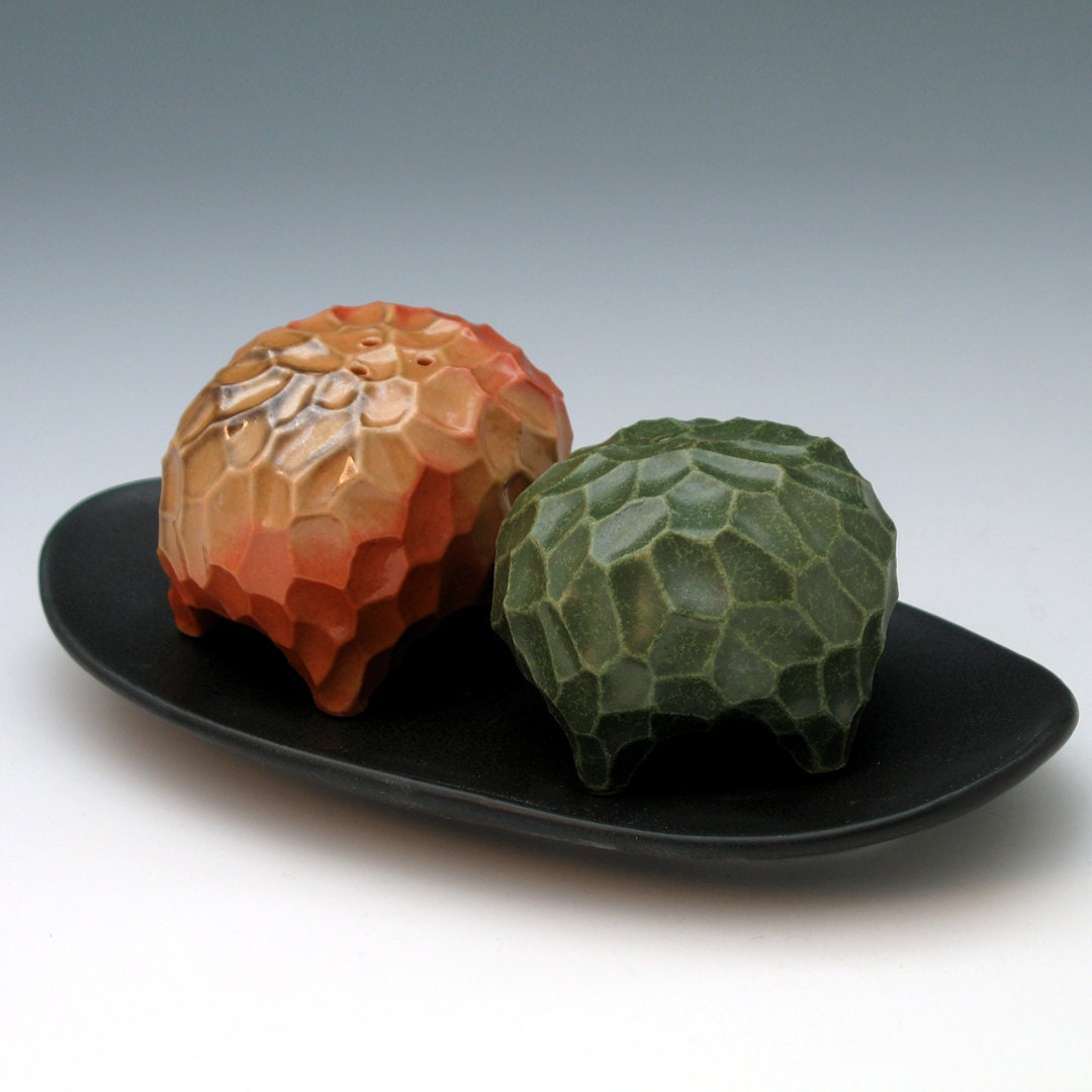 Orange and green carved porcelain salt & pepper set with black tray