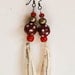 Earrings with wild boar ivory and trade beads