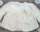 Baby's traditional yellow lacy matinee jacket