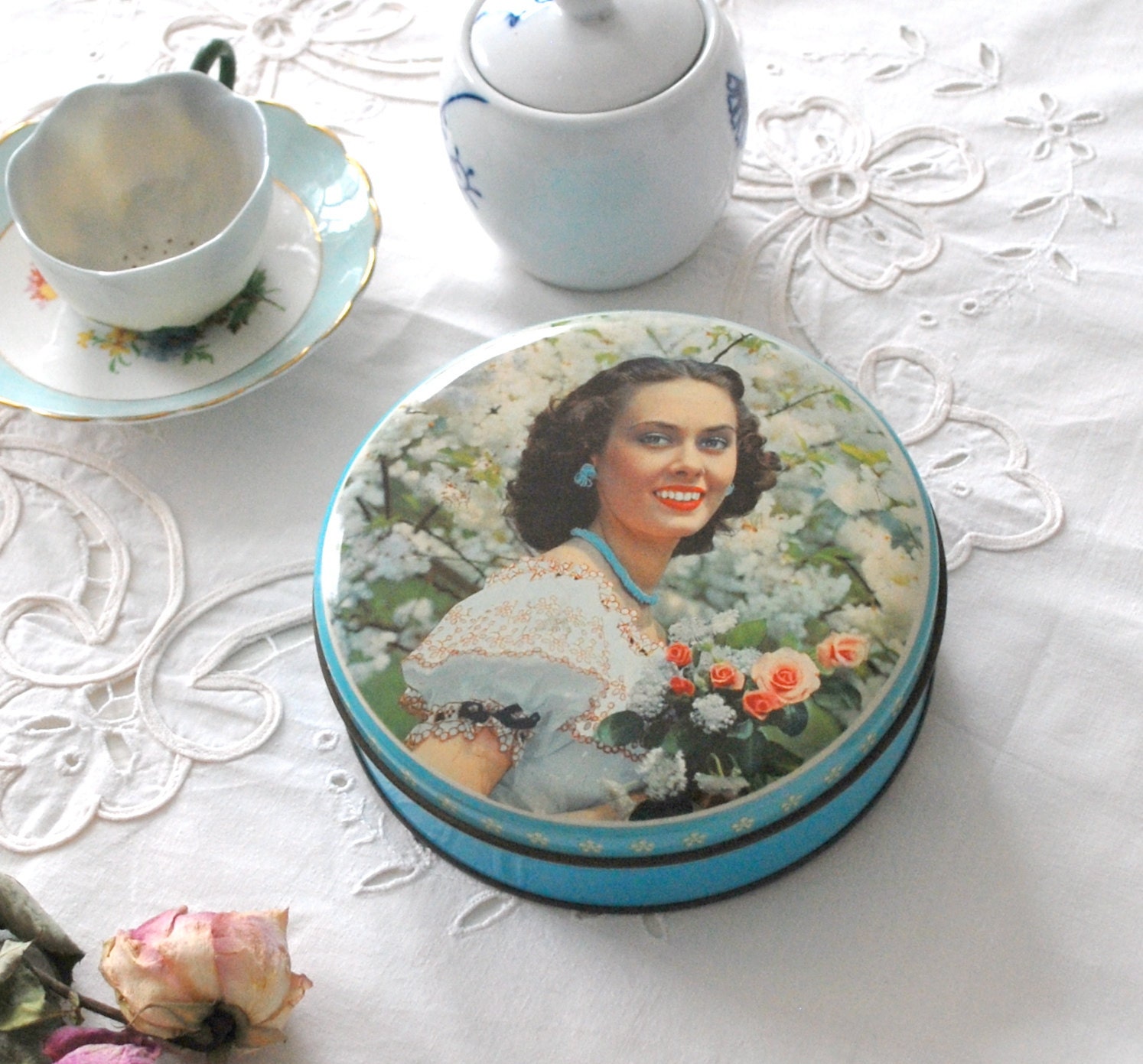 Vintage tin box with portrait of pretty girl in sky blue, spring flowers, vintage decor.