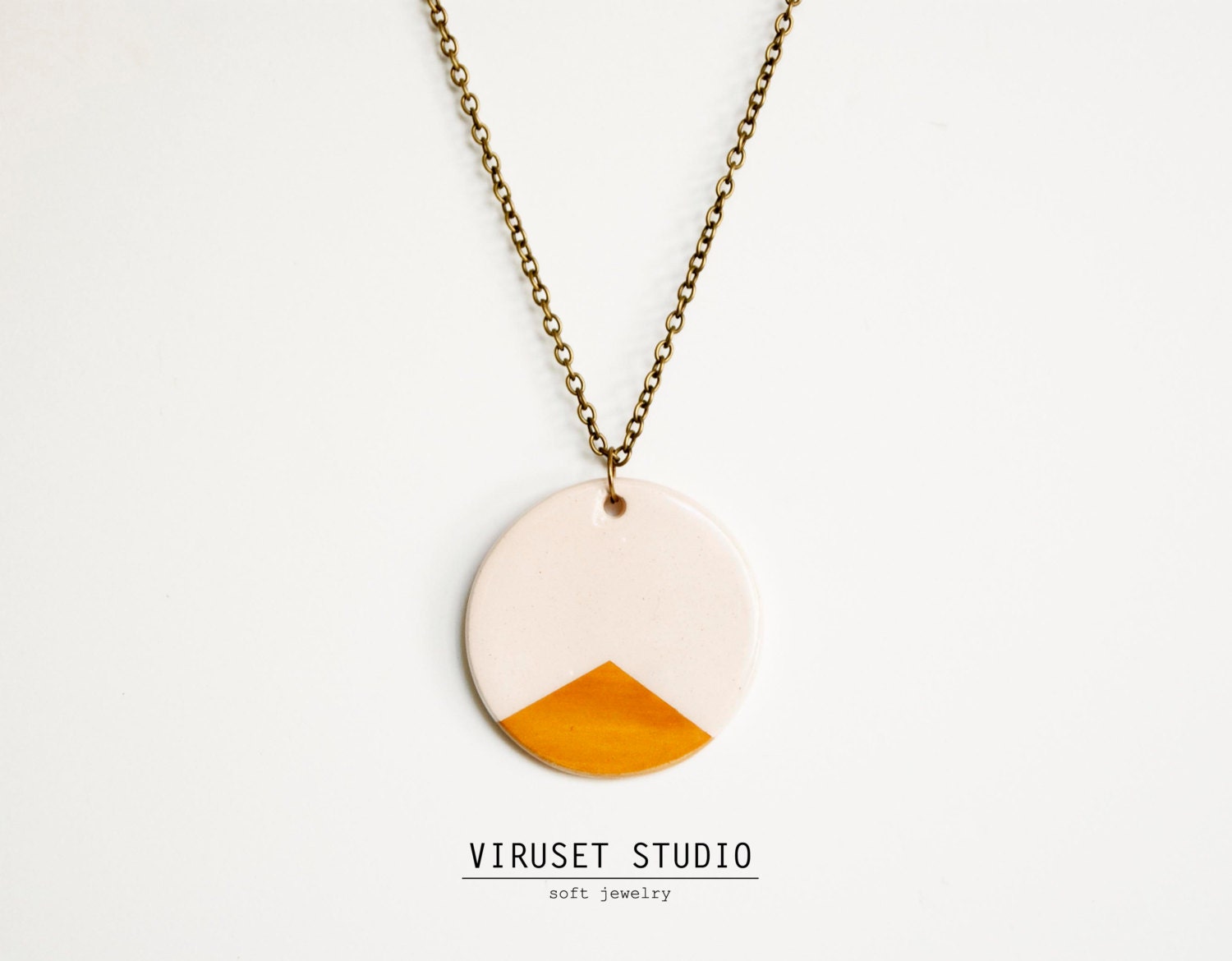 Ceramic pendant with white and orange geometric decoration. Handmade minimalist ceramic necklace. Viruset Studio