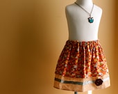 Little Girls Layer Skirt   flowers over wood grain, button and ribbon trim     6-12 mo,12-18 mo,2T,3T,4T,5T