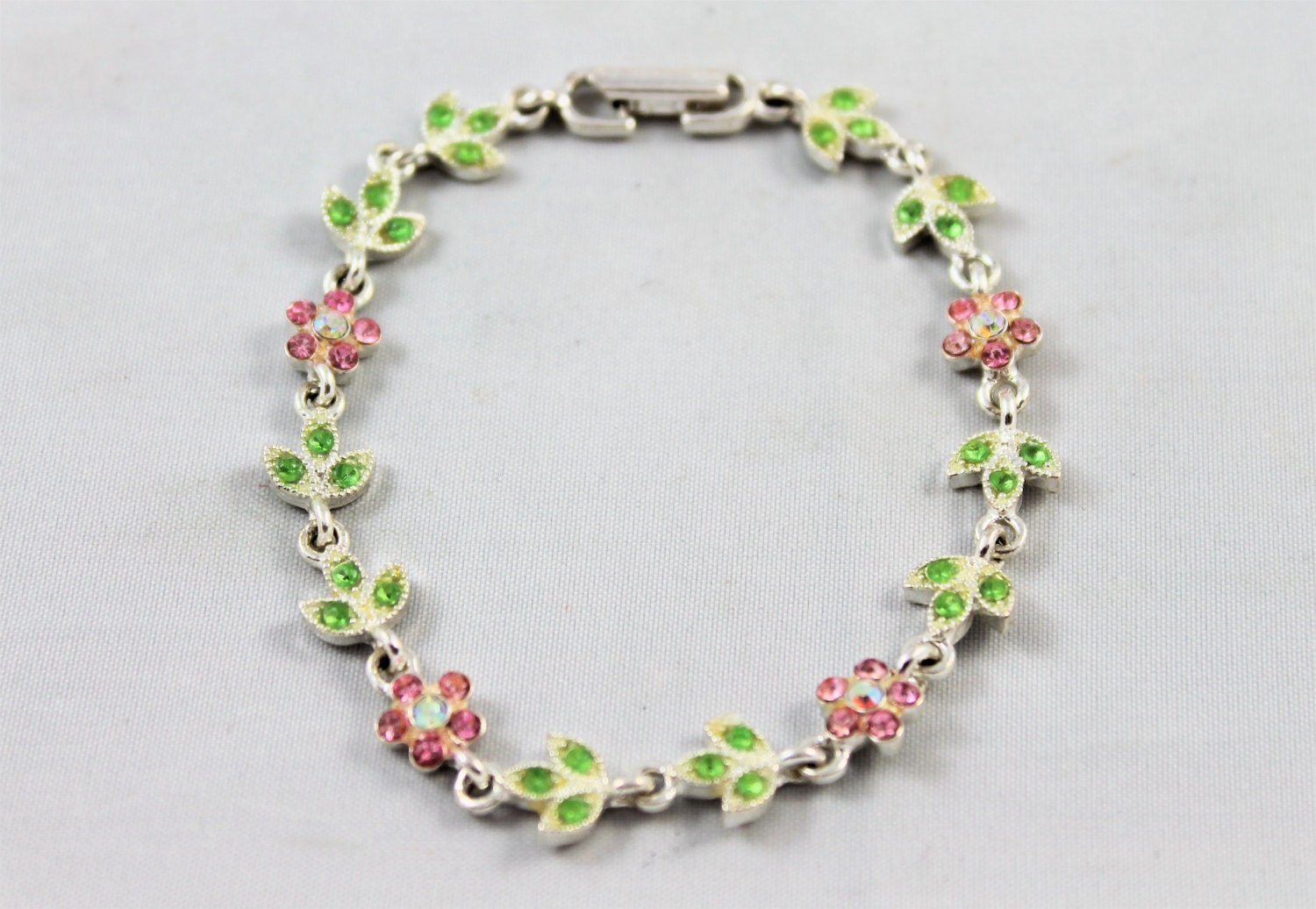 Avon rhinestone flower bracelet green pink silver signed  shiny feminine clean vintage