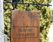 Personalized sign hanging from metal post. Painted on barn wood.
