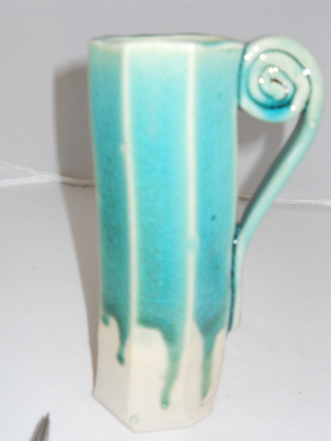 Blue ice glaze on octogon porcelain cup with fruit roll handle