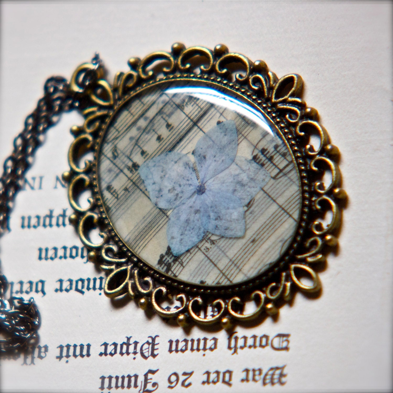 pressed flower jewelry resin pendant blue hydrangea on vintage music bronze setting extra long chain green