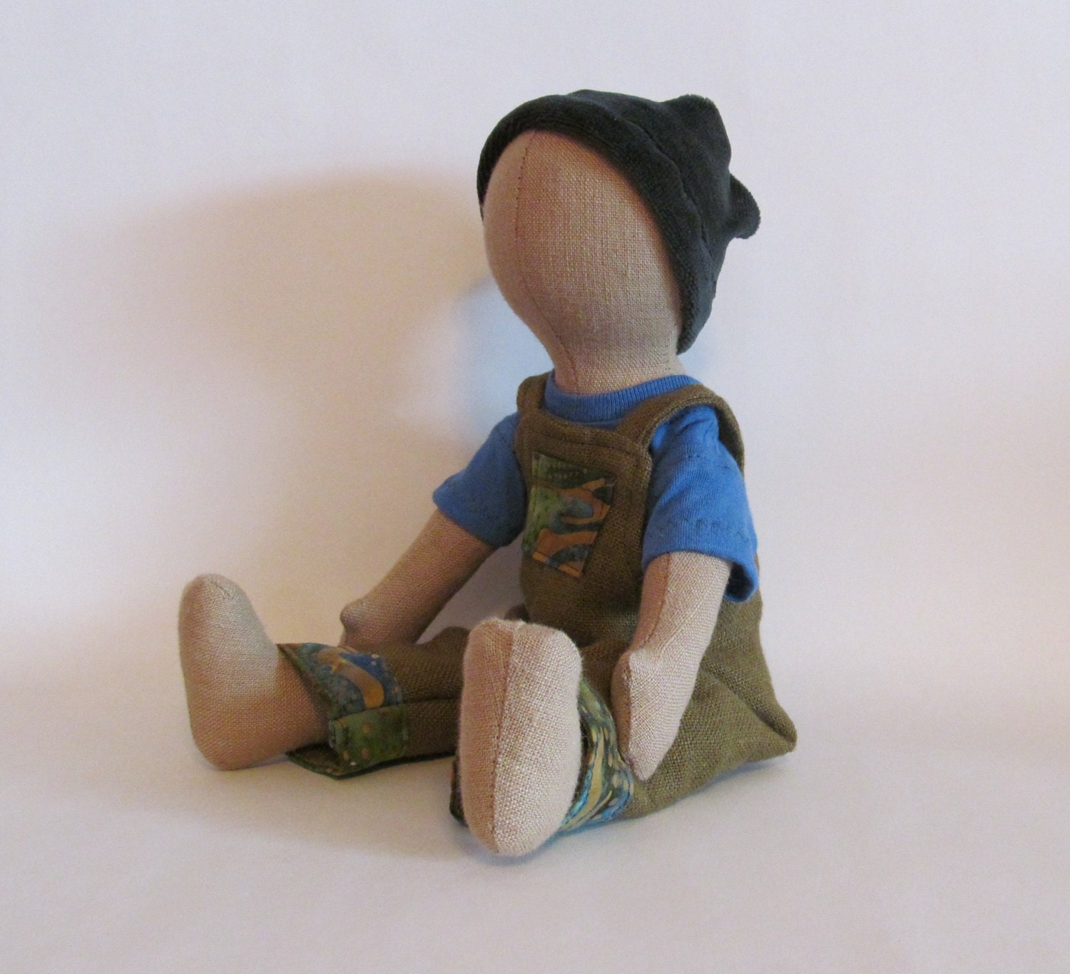 11" Eco-friendly tan doll with blue, green, and brown overalls