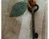 Leather strap necklace with vintage key and leaf bead.
