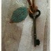 Leather strap necklace with vintage key and leaf bead.