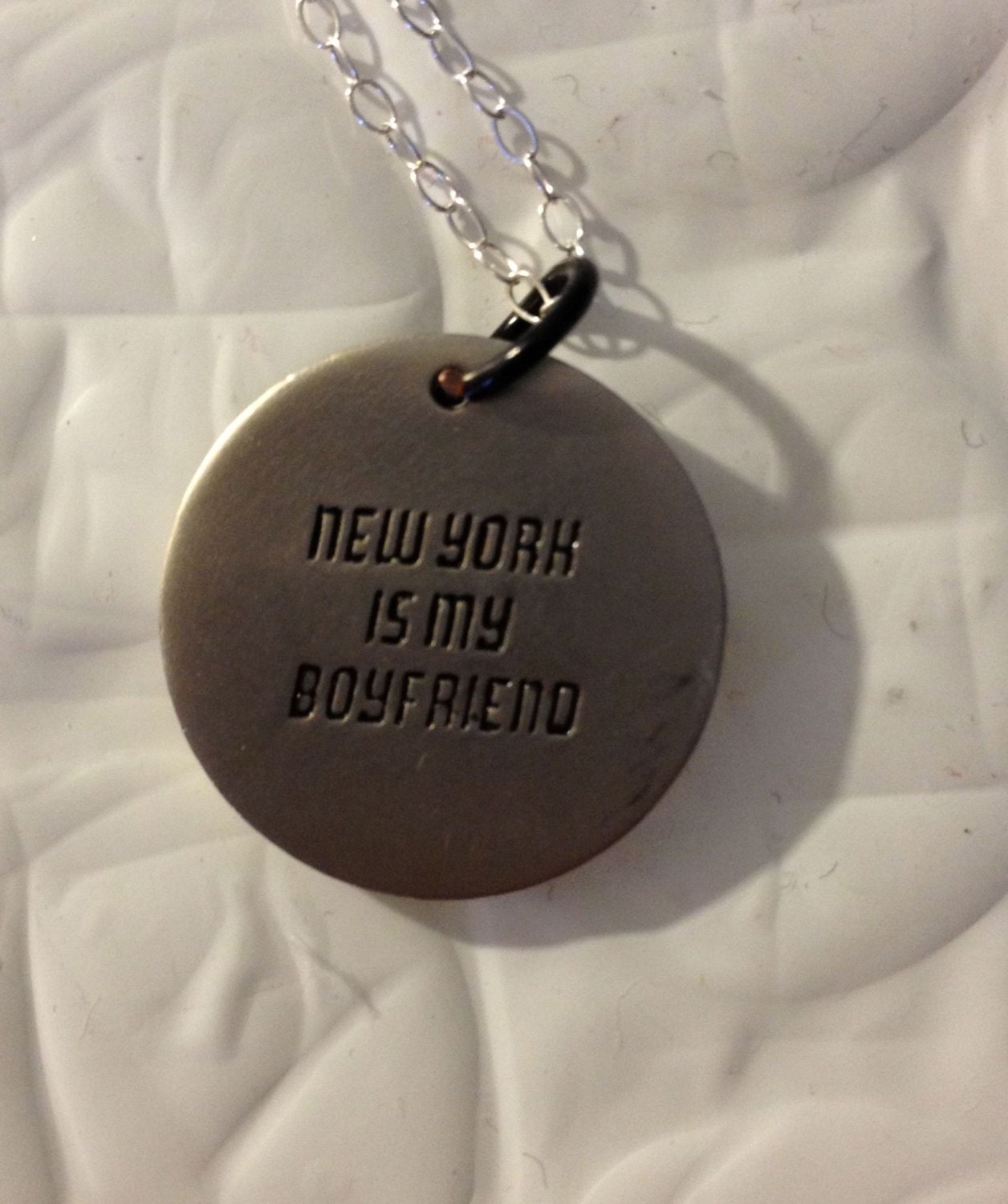 cast metal charm reading, "new york is my boyfriend"