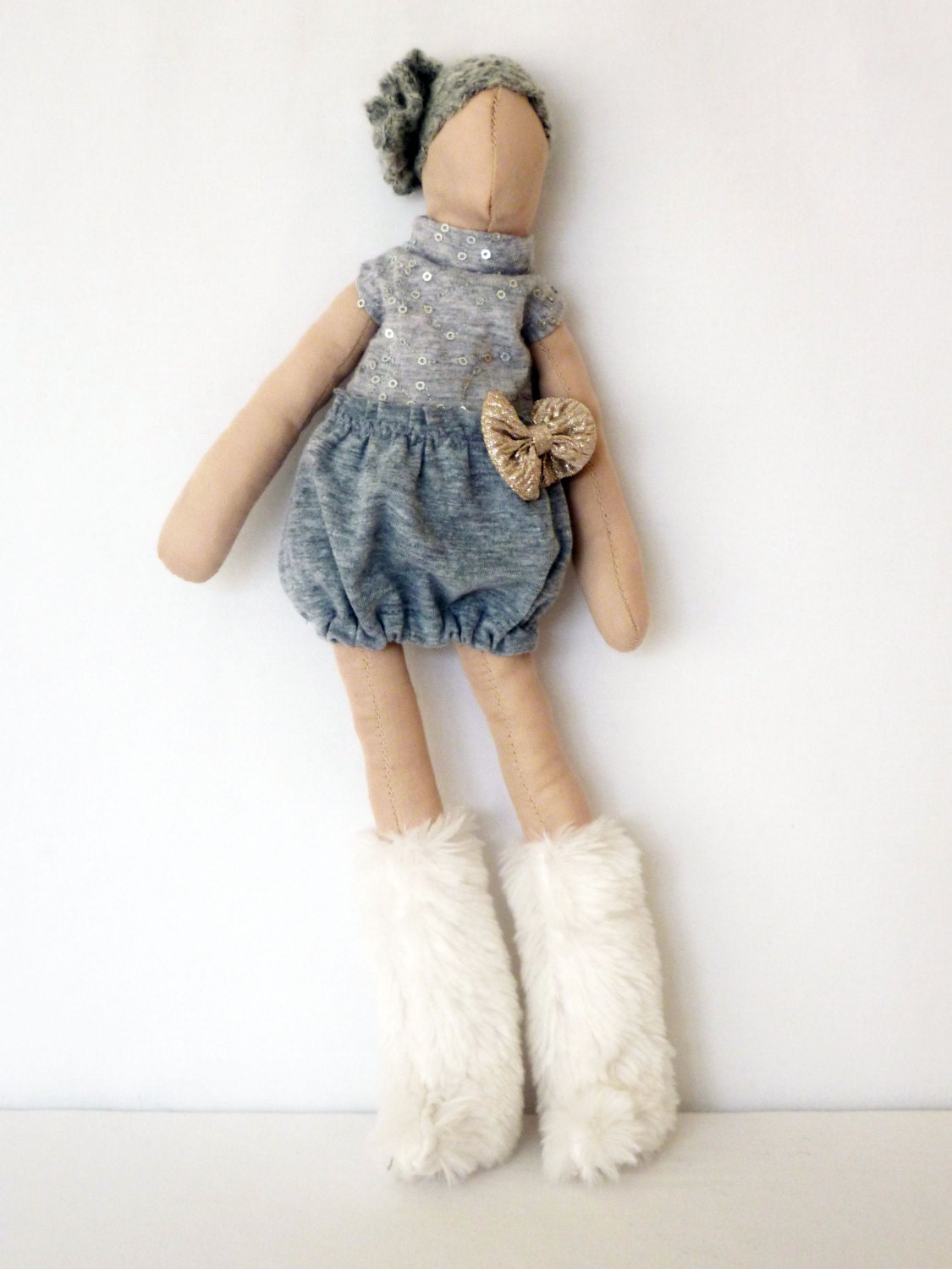 Handmade fabric doll in bow detal dress with furry boots