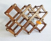 Vintage expanding wood wine rack folds flat for storage.  Wooden wine bottle holder, folding.