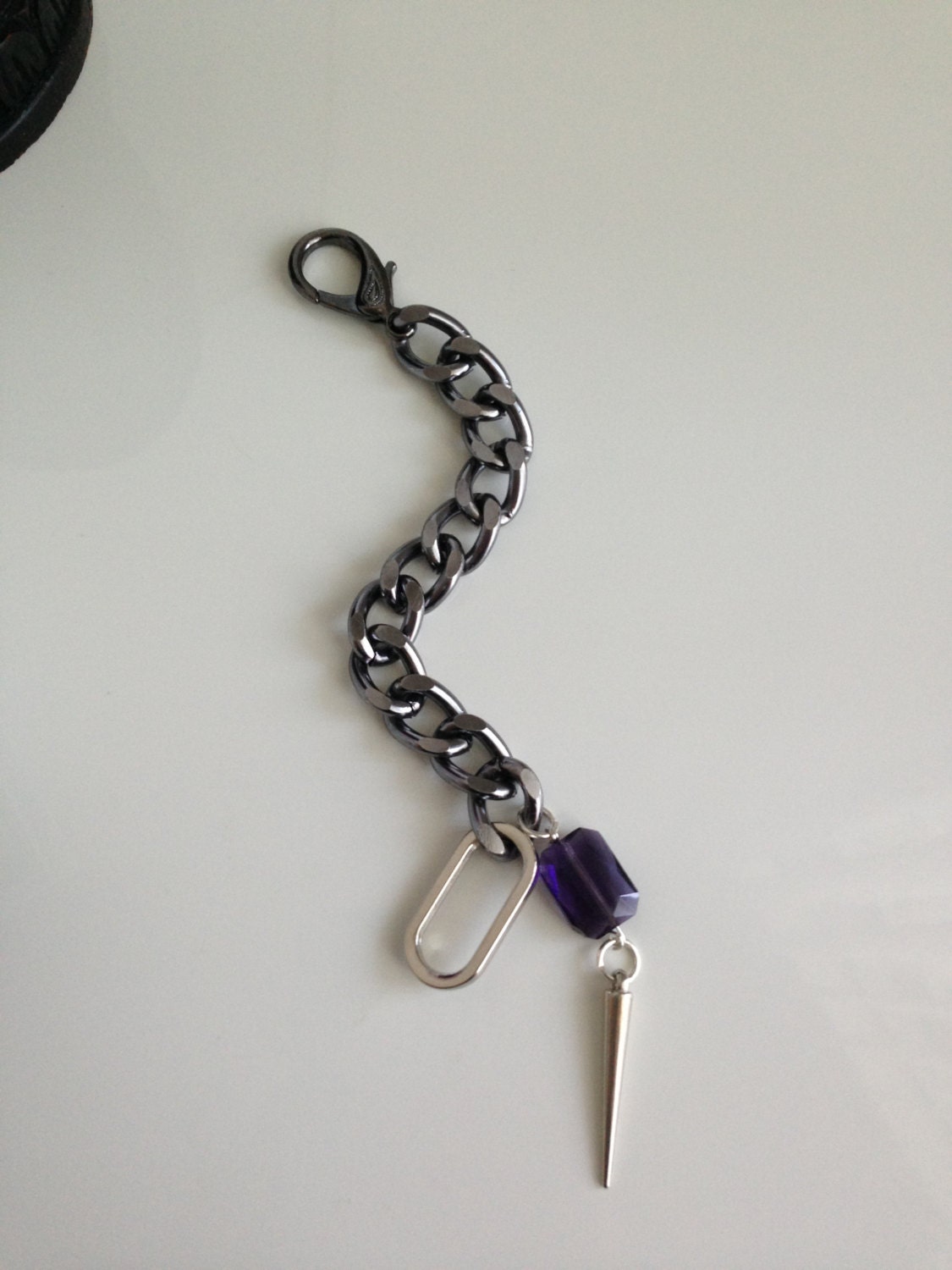 Spiked out Bracelet. Gunmetal chain bracelet with silver spike and purple stone 